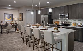 Phoenix apartment for rent - a kitchen with a large center island with a white counter top and chairs