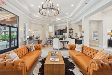 Lebanon apartment for rent - A living room with a brown leather sofa and a wooden coffee table.