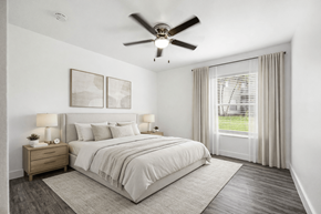 Naples apartment for rent - A bedroom with a large bed, a ceiling fan, and a window with curtains.