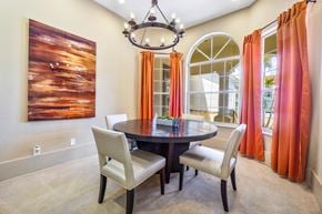 Sunrise apartment for rent - A dining room with a table, chairs and a painting on the wall.