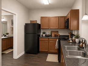 Savannah apartment for rent - A kitchen with a black refrigerator and wooden cabinets.