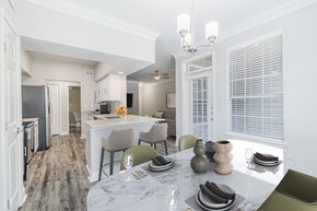 Houston apartment for rent - an open kitchen and dining room with a marble table and chairs