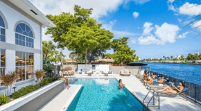 Fort Lauderdale apartment for rent - A group of people are enjoying the sun by a pool.