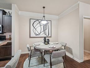 Apex apartment for rent - A dining room with a table set for two and a modern art piece on the wall.