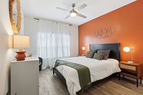 Antioch apartment for rent - A bedroom with a bed, nightstand, and a ceiling fan.