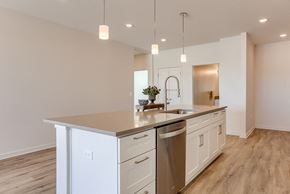 Omaha apartment for rent - A modern kitchen with a stainless steel dishwasher and white cabinets.