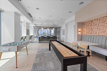 Raleigh apartment for rent - A modern living room with a long wooden table and chairs.