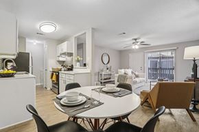 Austin apartment for rent - A modern dining room with a white table and chairs.