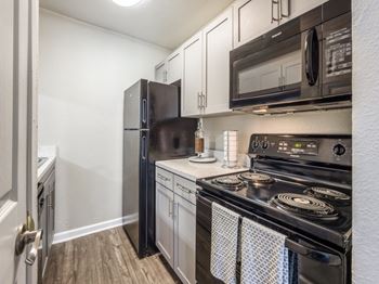 Stylish gray shaker-style cabinets with sleek stainless steel pulls*