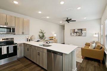 Fort Worth apartment for rent - A modern kitchen with a stainless steel dishwasher and a white countertop.