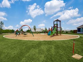 Fort Worth apartment for rent - A playground with a green slide and a red swing set.