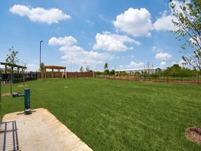 Fort Worth apartment for rent - A large grassy field with a wooden structure in the distance.