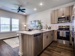 Fort Worth apartment for rent - A modern kitchen with a large island and stainless steel appliances.