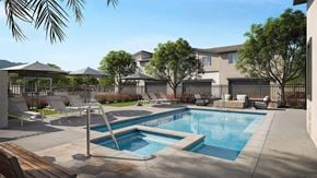 Phoenix apartment for rent - A swimming pool surrounded by a patio with chairs and umbrellas.