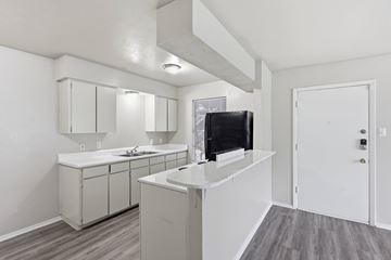 Stephenville apartment for rent - A kitchen with white cabinets and a black television.