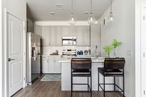 Aurora apartment for rent - A kitchen with a white cabinet and a white fridge.