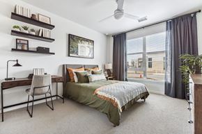 Aurora apartment for rent - A bedroom with a bed, desk, and chair.