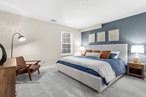 Howell townhouse for rent - a bedroom with a bed and a desk with a chair