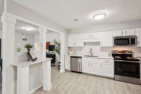 Marietta apartment for rent - A kitchen with white cabinets and a wooden island.