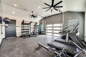 Anna apartment for rent - A spacious home gym with a treadmill, weights, and exercise equipment.