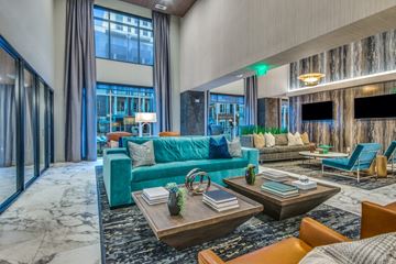 Farmers Branch apartment for rent - A modern living room with a blue couch and a coffee table.