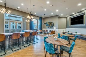 Farmers Branch apartment for rent - A modern dining area with a wooden table surrounded by chairs.