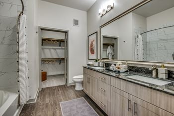 Laminate wood-style flooring with plush carpet in bedrooms and closets