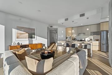 San Diego apartment for rent - A modern living room with a grey sofa and a wooden coffee table.