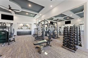 Fort Worth apartment for rent - A spacious gym with a variety of equipment including treadmills, weights, and exercise machines.