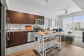 Dallas apartment for rent - A modern kitchen with a dining table and chairs.