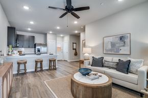 Lavon apartment for rent - A modern living room with a ceiling fan and a white couch.