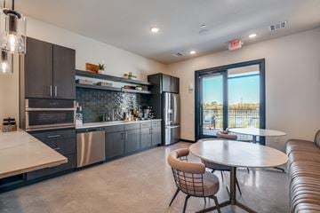 Lavon apartment for rent - A modern kitchen with a dining table and chairs.