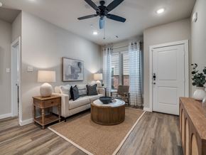 Lavon apartment for rent - A living room with a couch, a coffee table, and a ceiling fan.