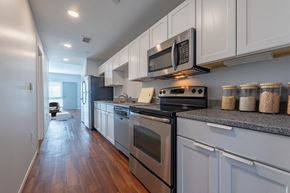 Winston Salem apartment for rent - a kitchen with stainless steel appliances and white cabinets