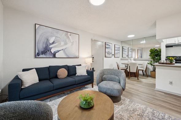 Austin apartment for rent - A living room with a blue couch and a grey armchair.