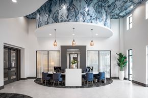 Houston apartment for rent - a large room with a table and chairs and a blue and white ceiling