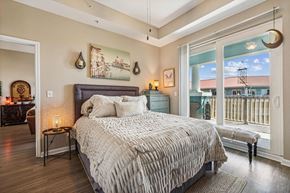 Panama City Beach apartment for rent - A bedroom with a large bed and a view of the city.