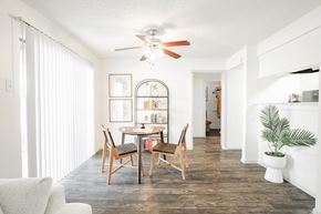 Dallas apartment for rent - a dining room with a table and chairs and a ceiling fan