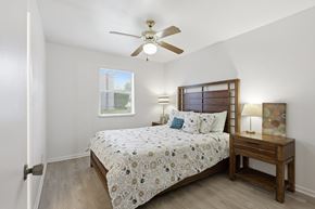 Stephenville apartment for rent - A bedroom with a bed, nightstand, and window.