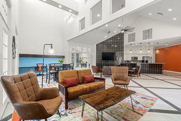 Pflugerville apartment for rent - A living room with a brown chair and a brown couch.