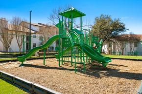 Fort Worth apartment for rent - a playground with a green playset in a park