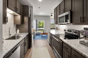 Katy apartment for rent - a kitchen with granite counter tops and stainless steel appliances