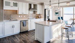 Minneapolis apartment for rent - A kitchen with white cabinets and a wooden island.