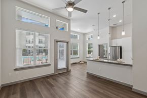 Katy apartment for rent - A spacious room with a ceiling fan and a long counter.