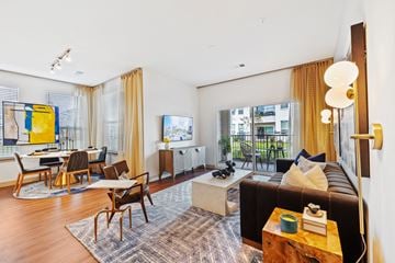 Spring apartment for rent - A living room with a brown couch and a coffee table.