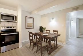 Phoenix apartment for rent - A kitchen with a table and chairs and a fridge.