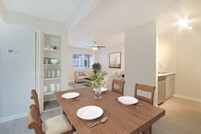 Phoenix apartment for rent - A dining room with a wooden table set for two.