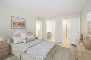 Phoenix apartment for rent - A bedroom with a large bed and a painting on the wall.