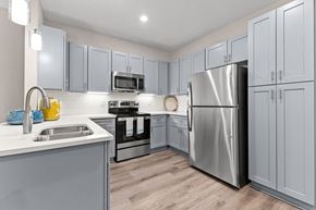 Knightdale apartment for rent - Active Adult  kitchen with stainless steel appliances and white cabinets