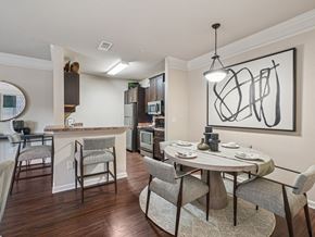 Apex apartment for rent - A modern kitchen with a dining table set for two.